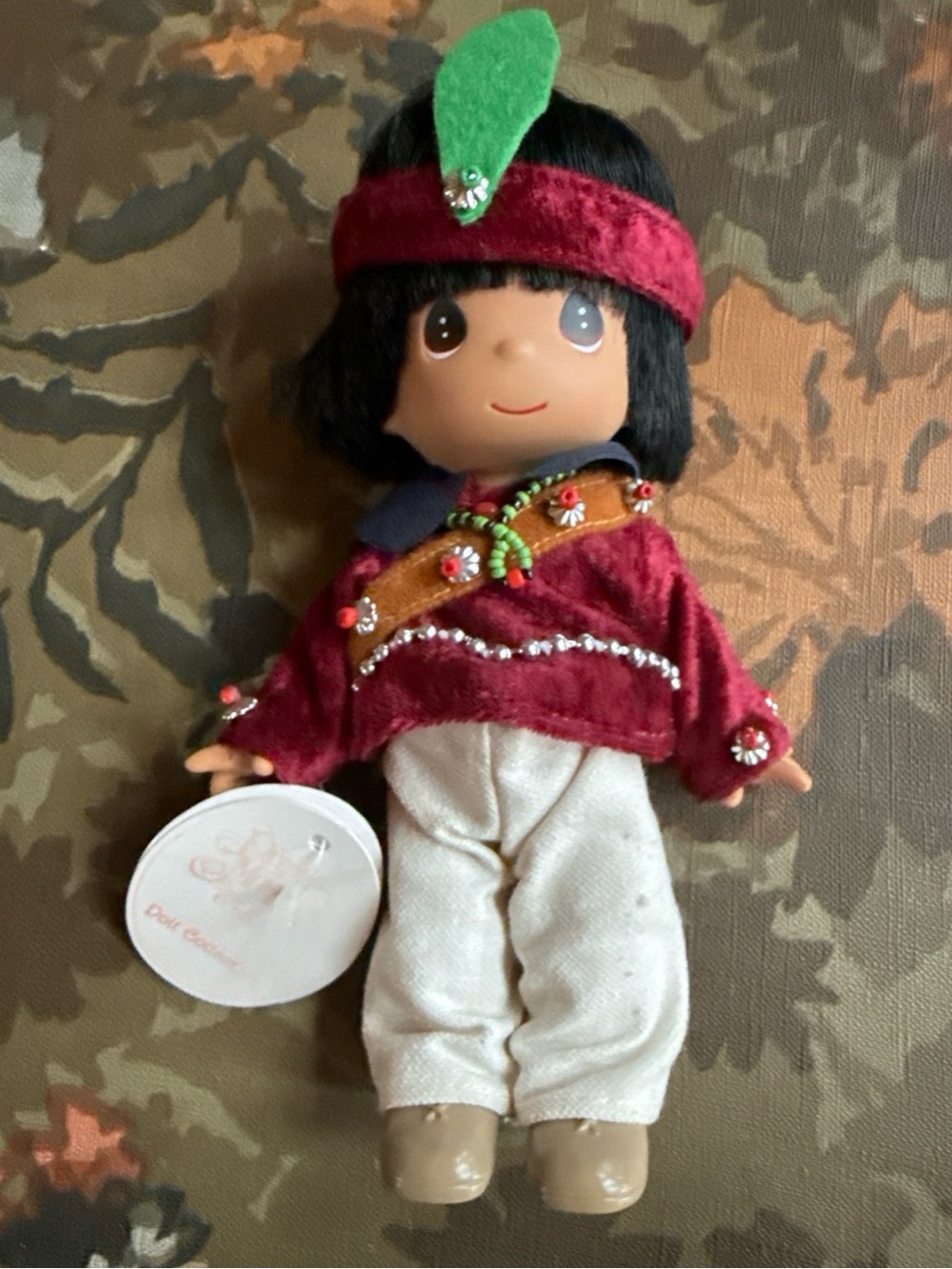Precious Moments Doll in Red Velvet Outfit with Green Feather